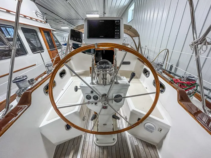 Golden Eye Yacht Photos Pics Cockpit of 1996 Hinckley Sou'wester 42 MKII sailboat with wooden steering wheel and navigation equipment.