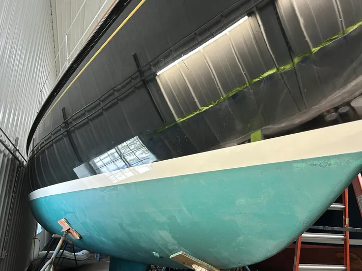 Golden Eye Yacht Photos Pics Hinckley Sou'wester 42 MKII sailboat, 1996 model, in storage with a sleek black and turquoise hull.