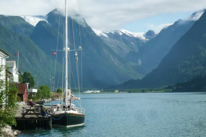 Golden Eye Yacht Photos Pics Sailboat Hinckley Sou'wester 42 MKII, 1996, docked by scenic fjord with snow-capped mountains.