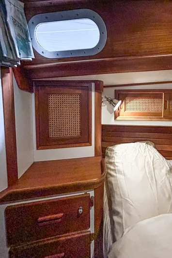 Golden Eye Yacht Photos Pics Hinckley Sou'wester 42 MKII 1996 cabin interior with wood paneling and porthole.