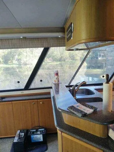  Yacht Photos Pics Interior of 2000 Bayliner 4788 Pilot House Motoryacht with kitchen and scenic window view.