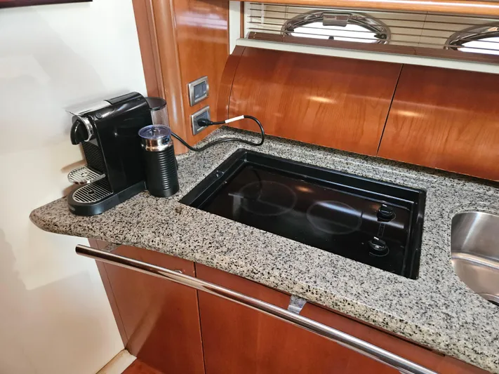 Nautical Dreamer Yacht Photos Pics Luxury yacht kitchen with granite countertop, coffee machine, and stove on 2005 Sea Ray 500 Sundancer.
