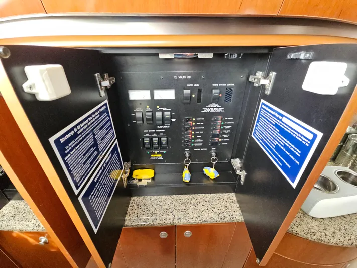 Nautical Dreamer Yacht Photos Pics Electrical panel inside 2005 Sea Ray 500 Sundancer yacht, featuring switches and safety instructions.
