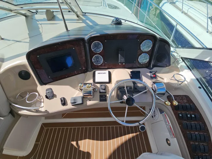 Nautical Dreamer Yacht Photos Pics Cockpit of 2005 Sea Ray 500 Sundancer with steering wheel and navigation instruments.