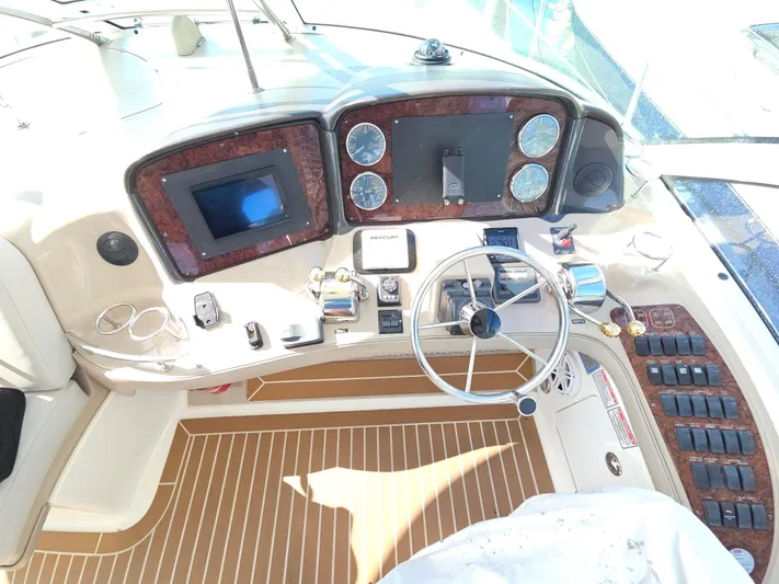 Nautical Dreamer Yacht Photos Pics 2005 Sea Ray 500 Sundancer helm with modern controls and wood accents.