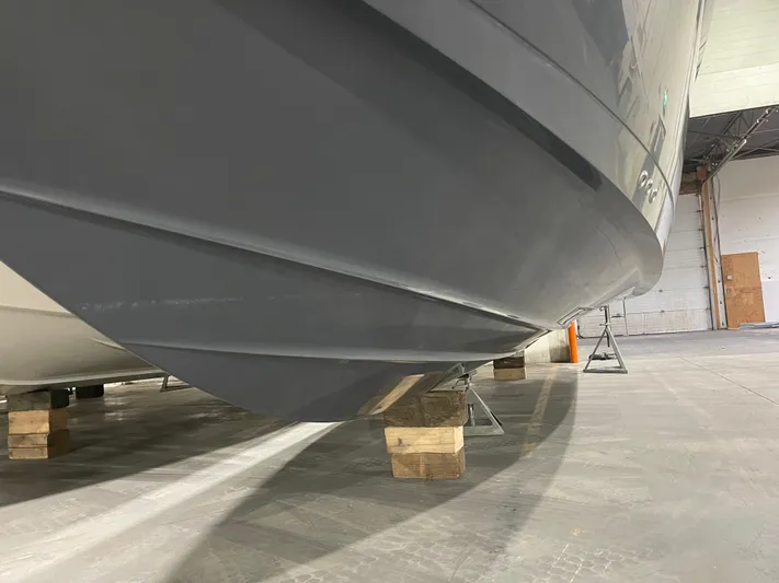  Yacht Photos Pics 2017 Cruisers Yachts 338 SOUTH BEACH hull in storage, supported by wooden blocks.