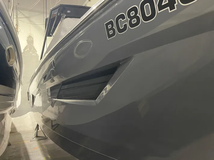  Yacht Photos Pics 2017 Cruisers Yachts 338 SOUTH BEACH, close-up of sleek hull design in storage.