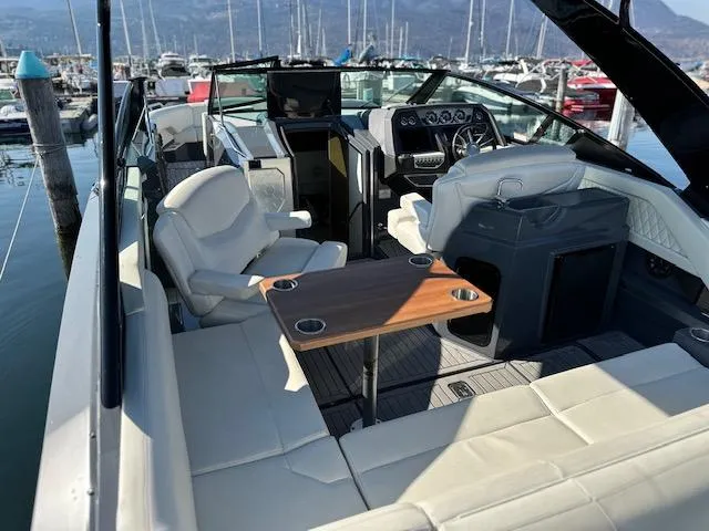  Yacht Photos Pics 2017 Cruisers Yachts 338 SOUTH BEACH interior with seating and table, docked at marina.