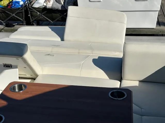  Yacht Photos Pics 2017 Cruisers Yachts 338 SOUTH BEACH interior with white seating and wooden table.