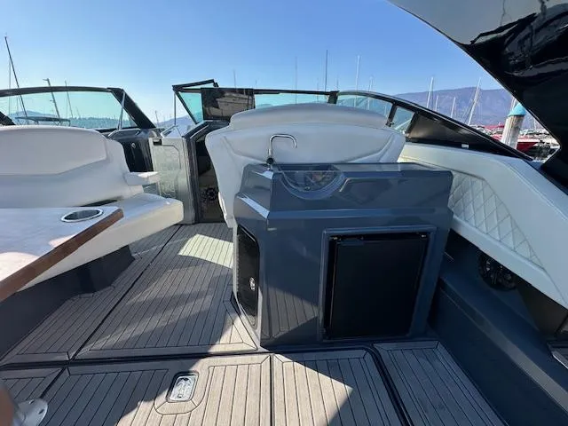  Yacht Photos Pics 2017 Cruisers Yachts 338 SOUTH BEACH interior with seating and helm, docked under clear skies.