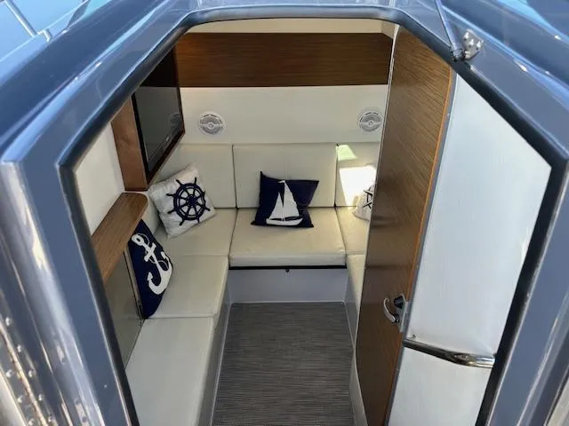  Yacht Photos Pics 2017 Cruisers Yachts 338 SOUTH BEACH cabin interior with nautical-themed cushions.
