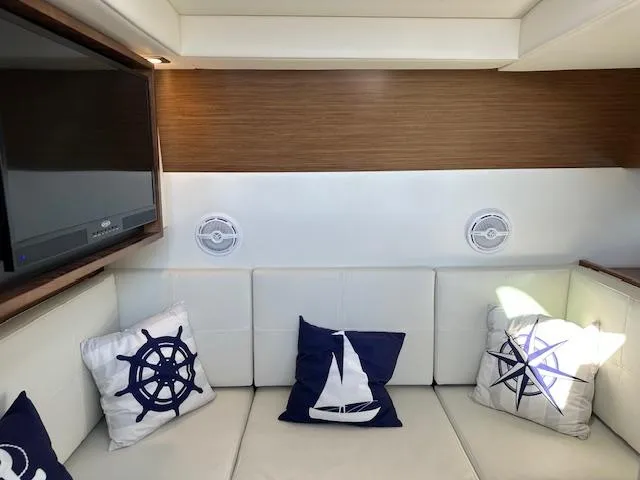  Yacht Photos Pics Interior of 2017 Cruisers Yachts 338 SOUTH BEACH with nautical-themed pillows and modern decor.
