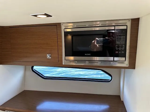 Yacht Photos Pics 2017 Cruisers Yachts 338 SOUTH BEACH interior with microwave and window view.