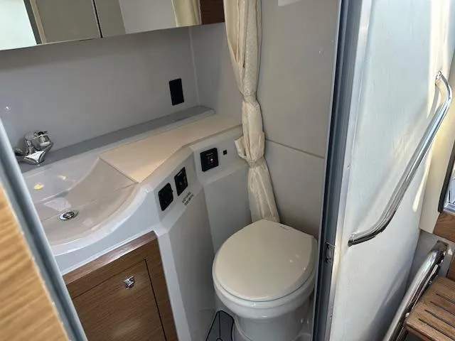  Yacht Photos Pics 2017 Cruisers Yachts 338 SOUTH BEACH bathroom with sink, toilet, and curtain.