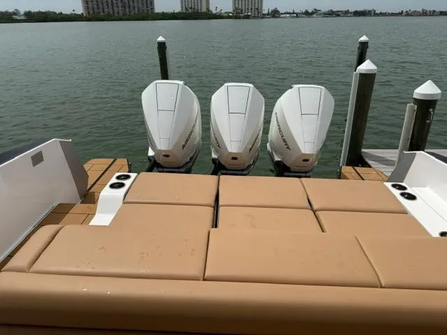  Yacht Photos Pics 2023 Aviara AV36 OB boat with triple outboard engines docked by the water.