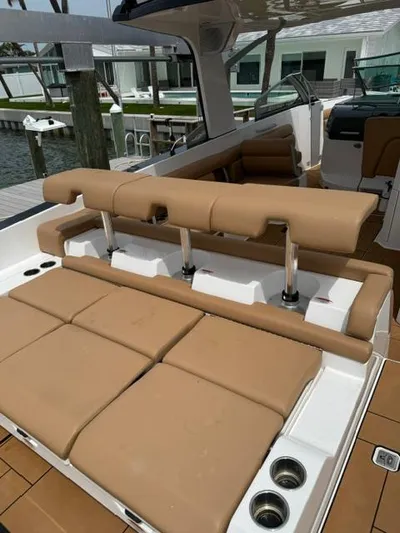  Yacht Photos Pics 2023 Aviara AV36 OB boat with tan seating and cup holders, docked near water.