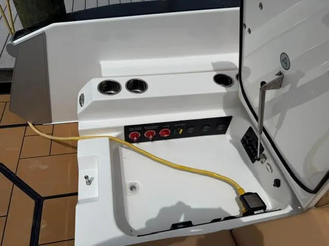  Yacht Photos Pics 2023 Aviara AV36 OB boat electrical panel with cup holders and yellow power cable.