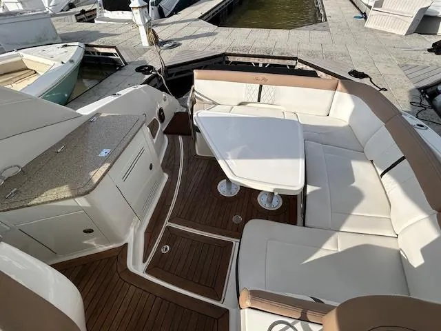  Yacht Photos Pics 2016 Sea Ray 350 Sundancer boat interior with seating and table, docked at marina.