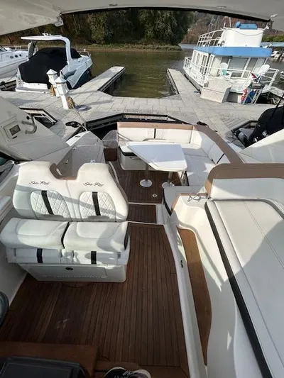 Yacht Photos Pics 2016 Sea Ray 350 Sundancer yacht interior with seating and table at a marina.