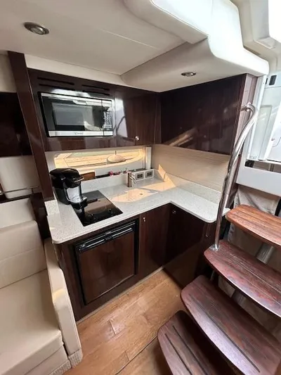  Yacht Photos Pics Luxurious 2016 Sea Ray 350 Sundancer yacht kitchen with modern appliances and elegant wood finishes.