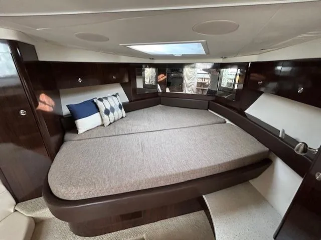  Yacht Photos Pics Luxurious interior cabin of 2016 Sea Ray 350 Sundancer yacht with plush bedding.