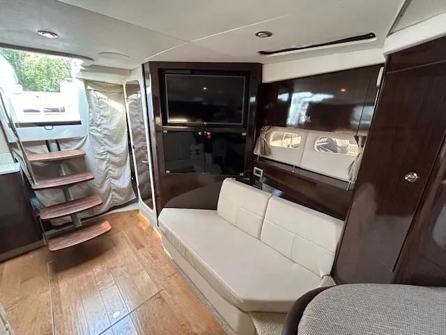  Yacht Photos Pics Luxurious interior of 2016 Sea Ray 350 Sundancer yacht with TV and seating area.