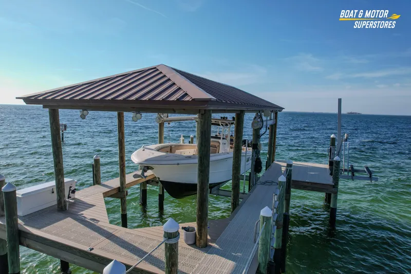  Yacht Photos Pics 2018 Key West Billistic 351 Center Console boat docked under a covered pier.