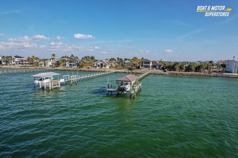  Yacht Photos Pics Aerial view of waterfront homes and docks on a sunny day, showcasing serene coastal living.