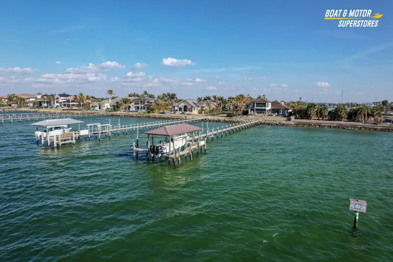  Yacht Photos Pics Aerial view of 2018 Key West Billistic 351 Center Console docked in a scenic waterfront area.