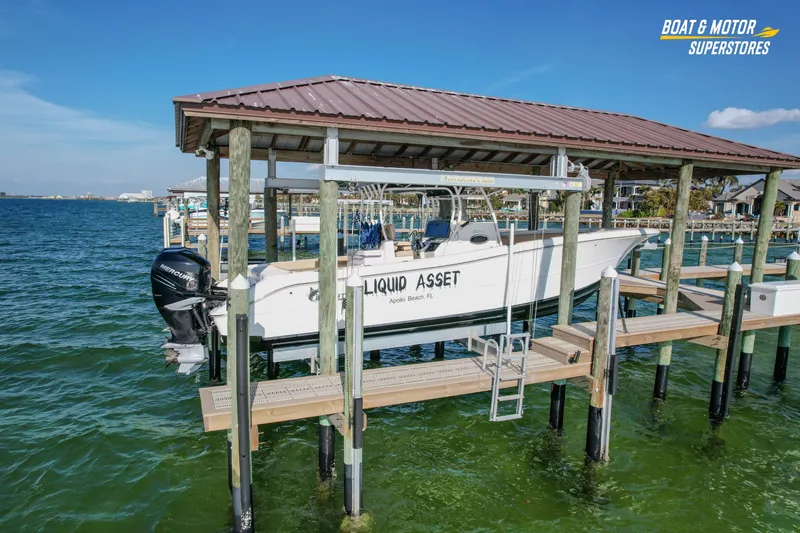  Yacht Photos Pics 2018 Key West Billistic 351 Center Console boat docked on a lift over water.