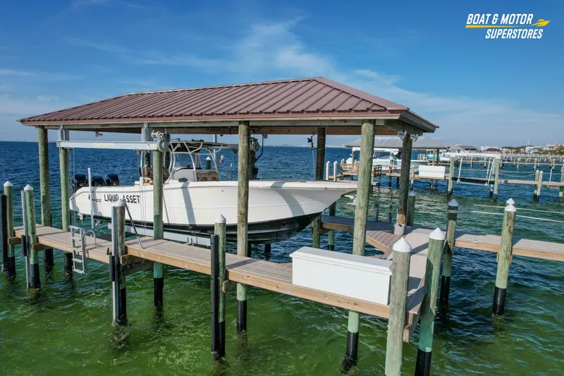  Yacht Photos Pics 2018 Key West Billistic 351 Center Console boat docked under a covered pier.
