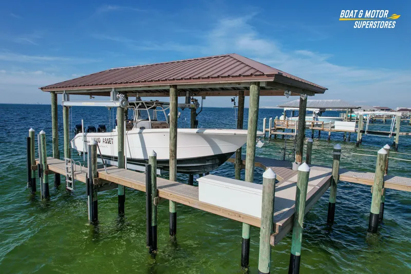  Yacht Photos Pics 2018 Key West Billistic 351 Center Console boat docked on a lift over clear water.