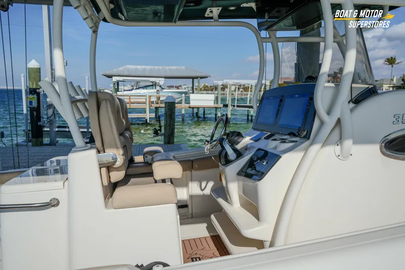  Yacht Photos Pics 2018 Key West Billistic 351 Center Console boat interior at dockside, featuring helm and seating.