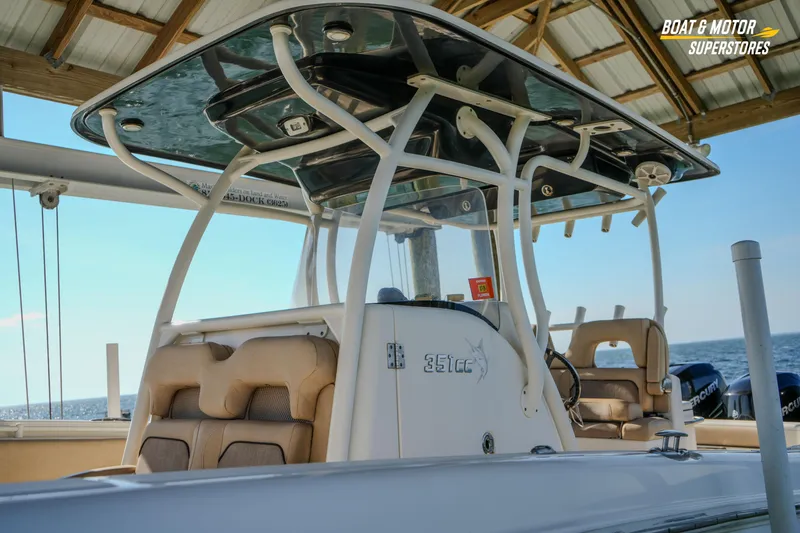 Yacht Photos Pics 2018 Key West Billistic 351 Center Console boat under a dock, featuring comfortable seating.