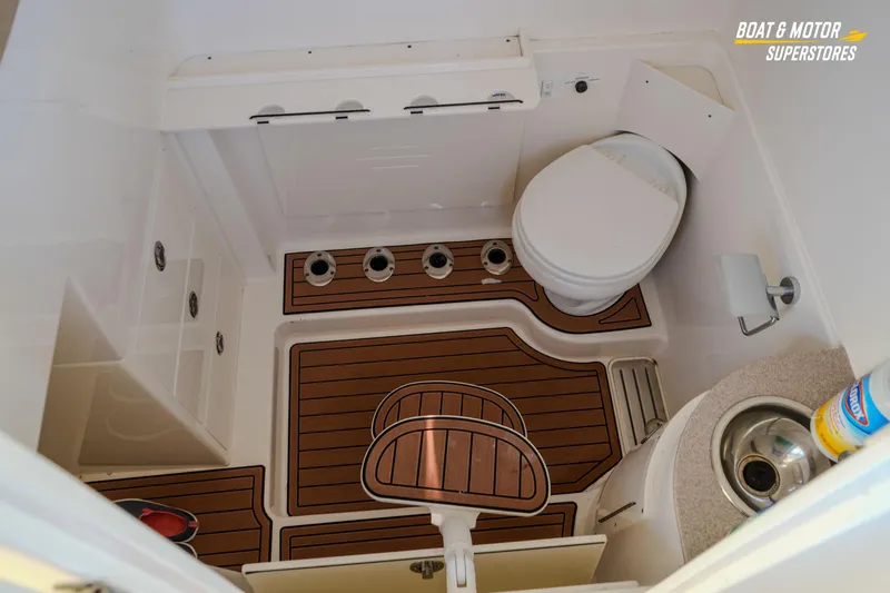  Yacht Photos Pics 2018 Key West Billistic 351 Center Console boat bathroom with wooden flooring and compact amenities.