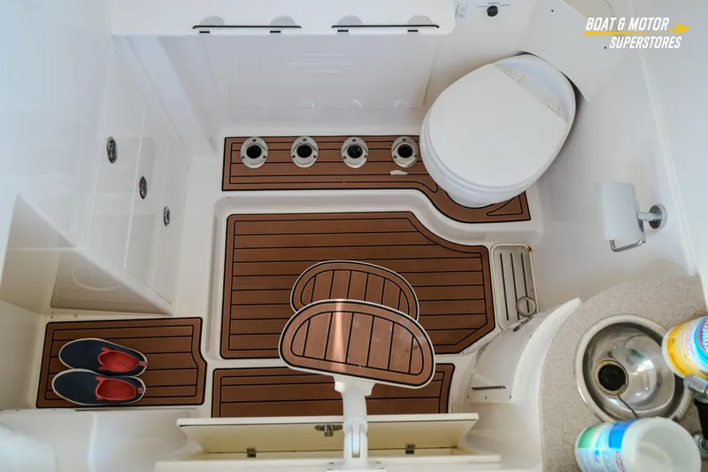 Yacht Photos Pics 2018 Key West Billistic 351 Center Console boat interior with toilet and wooden flooring.