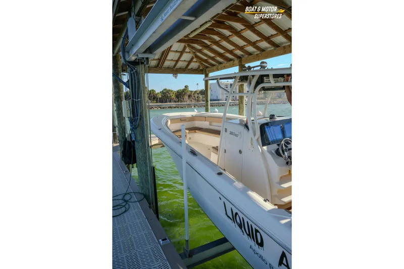  Yacht Photos Pics 2018 Key West Billistic 351 Center Console docked under a wooden shelter.