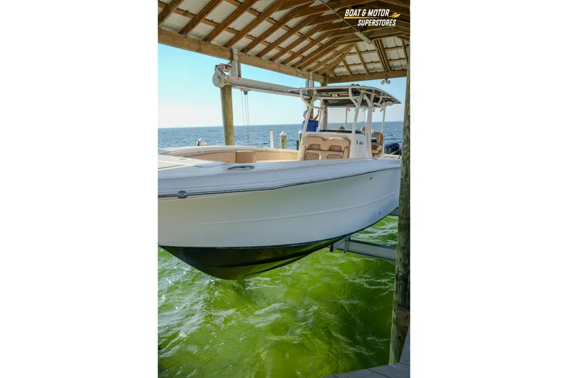  Yacht Photos Pics 2018 Key West Billistic 351 Center Console boat docked under a wooden canopy.