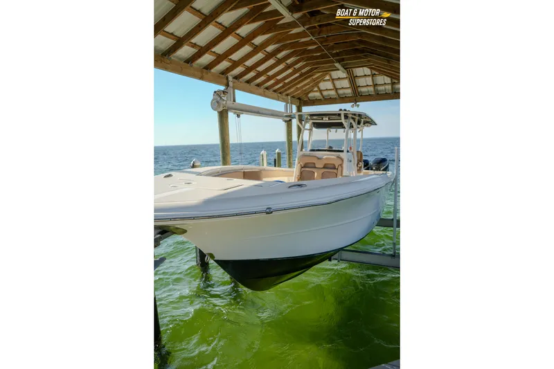  Yacht Photos Pics 2018 Key West Billistic 351 Center Console boat docked under a wooden shelter.