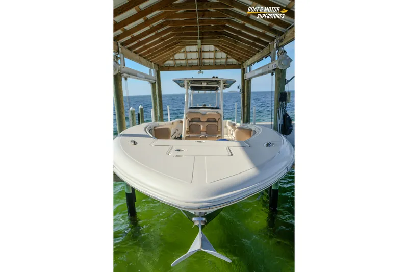  Yacht Photos Pics 2018 Key West Billistic 351 Center Console boat docked under a wooden shelter.