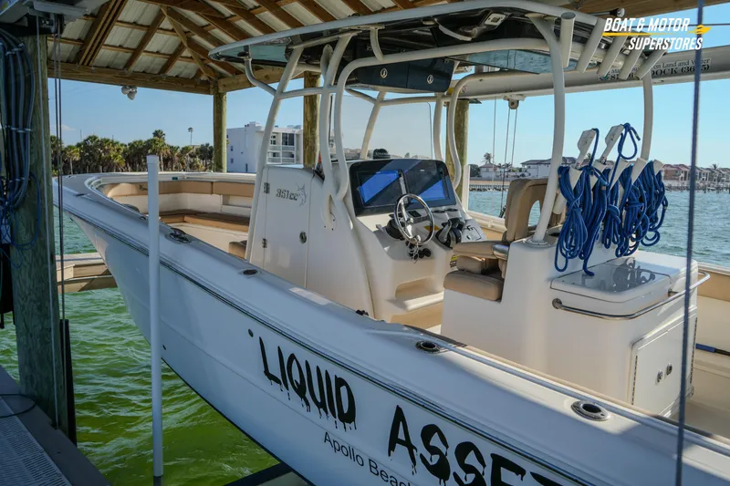  Yacht Photos Pics 2018 Key West Billistic 351 Center Console boat docked under a wooden canopy.