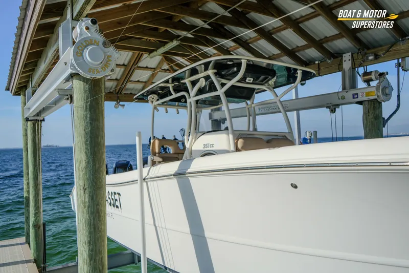  Yacht Photos Pics 2018 Key West Billistic 351 Center Console boat docked under a wooden canopy.