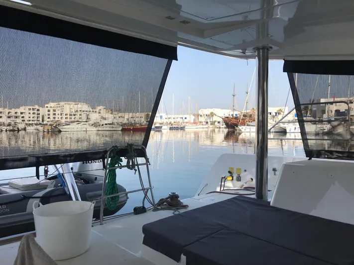 Matilda Mia Yacht Photos Pics 2015 Lagoon 52 yacht interior with marina view, featuring shaded seating area.