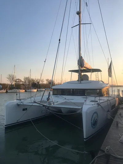 Matilda Mia Yacht Photos Pics 2015 Lagoon 52 catamaran docked at sunset, showcasing sleek design and spacious deck.