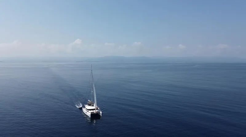 Matilda Mia Yacht Photos Pics Sailing Lagoon 52 catamaran on calm sea under clear blue sky, 2015 model.