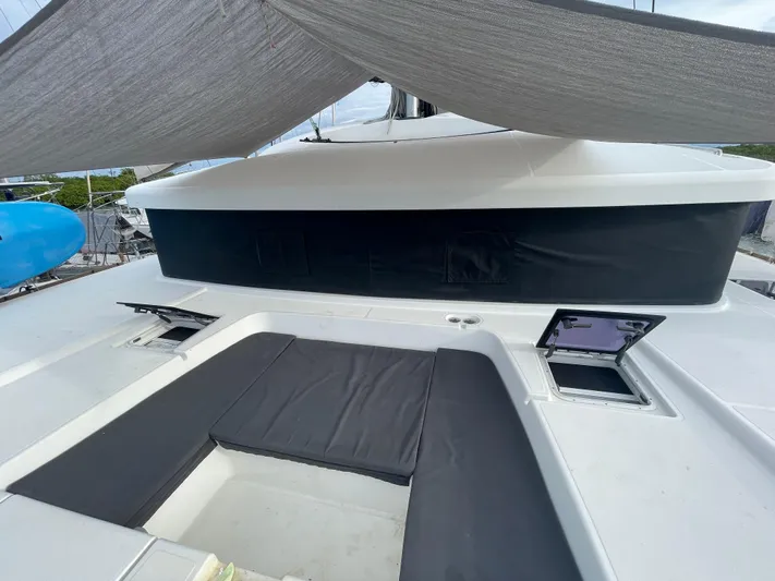 Matilda Mia Yacht Photos Pics 2015 Lagoon 52 yacht deck with cushioned seating and sunshade.