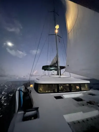 Matilda Mia Yacht Photos Pics Sailing Lagoon 52 yacht at dusk, 2015 model, with illuminated sails and moonlit sky.