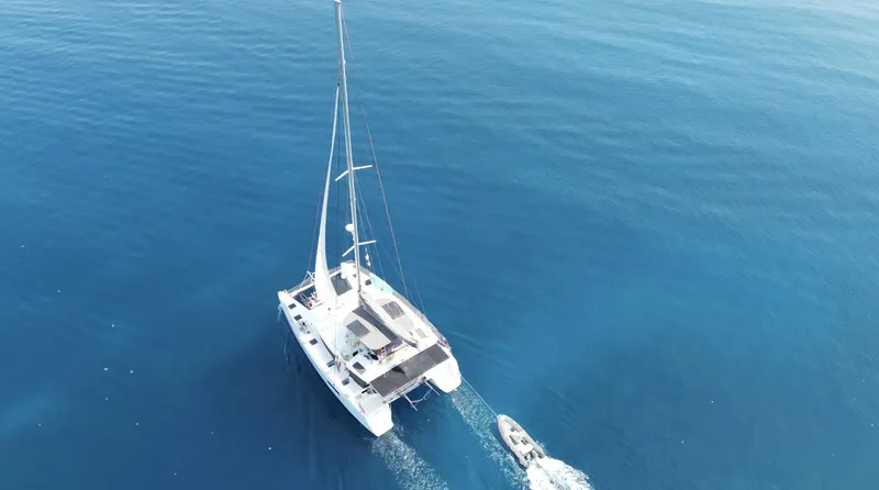 Matilda Mia Yacht Photos Pics Aerial view of 2015 Lagoon 52 catamaran sailing on clear blue ocean.