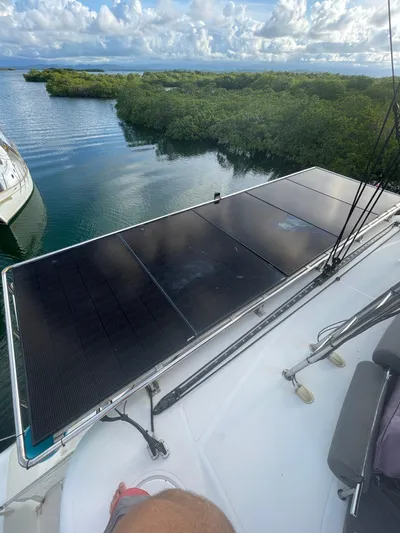 Matilda Mia Yacht Photos Pics Lagoon 52 catamaran with solar panels, 2015 model, docked near lush greenery and calm waters.