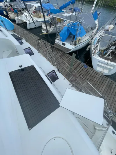 Matilda Mia Yacht Photos Pics 2015 Lagoon 52 yacht docked among sailboats, featuring solar panels and sleek design.